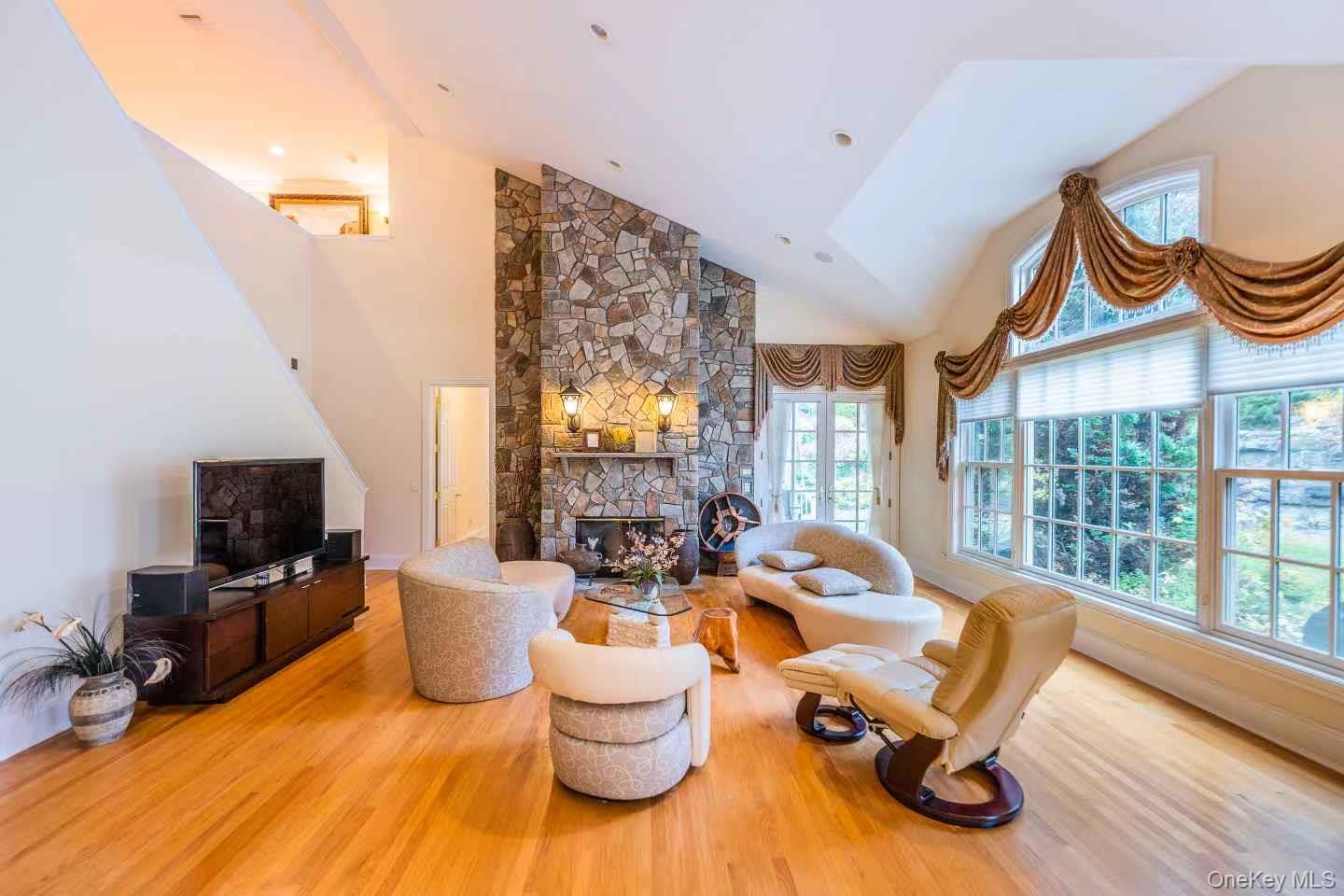 5 Westgate Road Muttontown, NY 11791 - Photo 12 of 42 a living room with furniture fireplace and flat screen tv