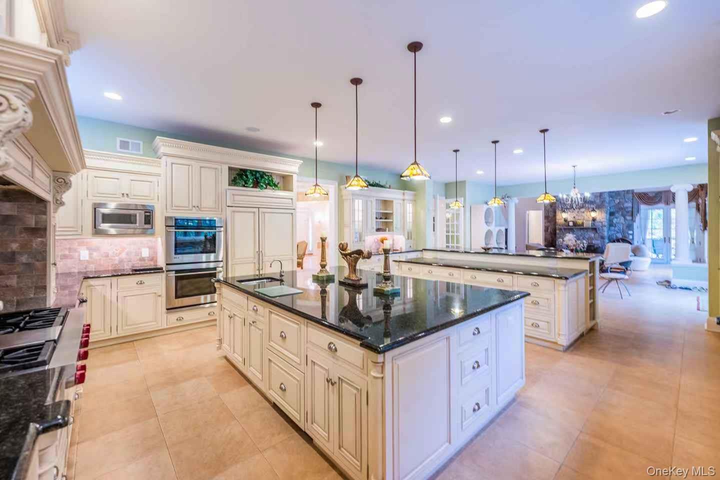 5 Westgate Road Muttontown, NY 11791 - Photo 18 of 42 a kitchen with kitchen island granite countertop a sink counter top stainless steel appliances and cabinets