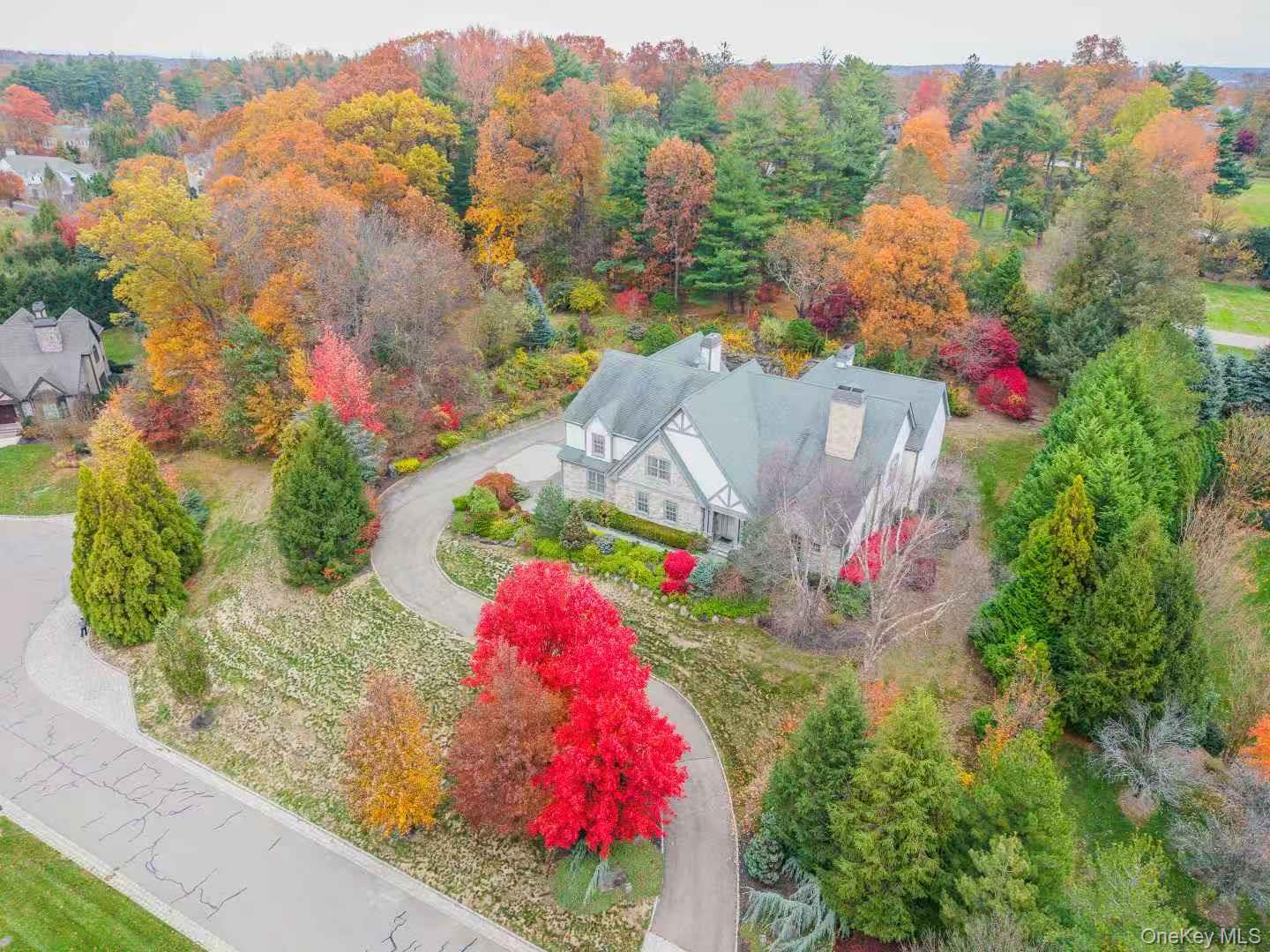 5 Westgate Road Muttontown, NY 11791 - Photo 5 of 42 a view of a white house with a lot of flower plants