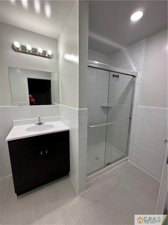 4202 Hana Road Edison, NJ 08817 - Photo 41 of 44 a bathroom with a sink vanity and a mirror
