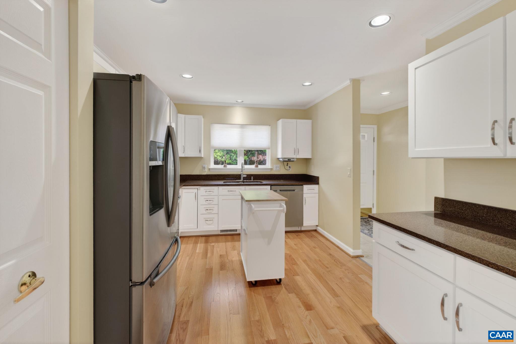 590 Mockingbird Way Charlottesville, VA 22901 - Photo 11 of 43 a kitchen with a refrigerator a sink and wooden cabinets
