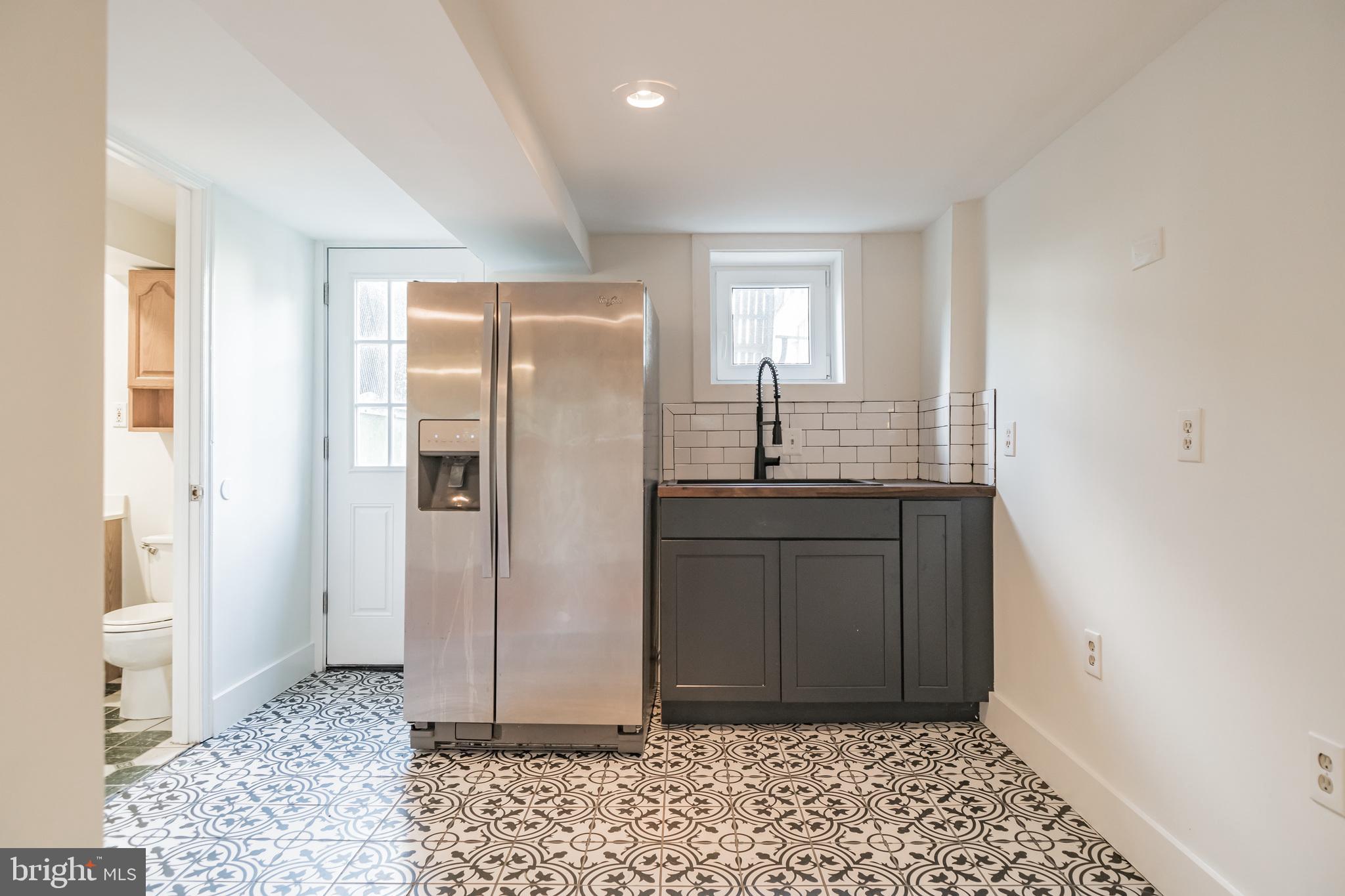 1348 G Street Southeast Washington, DC 20003 - Photo 37 of 41 Basement kitchenette & rear exit to backyard