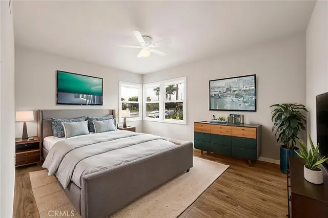 a bedroom with a bed and a dresser next to a window