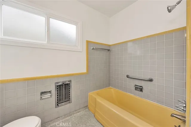 a bathroom with a blue tub shower and sink