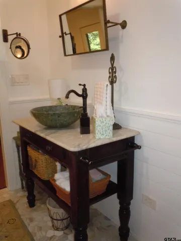 a white bath tub sitting in a bathroom and shower