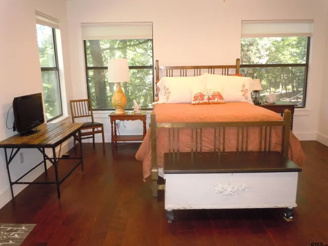 a bathroom with a granite countertop sink a toilet and a mirror