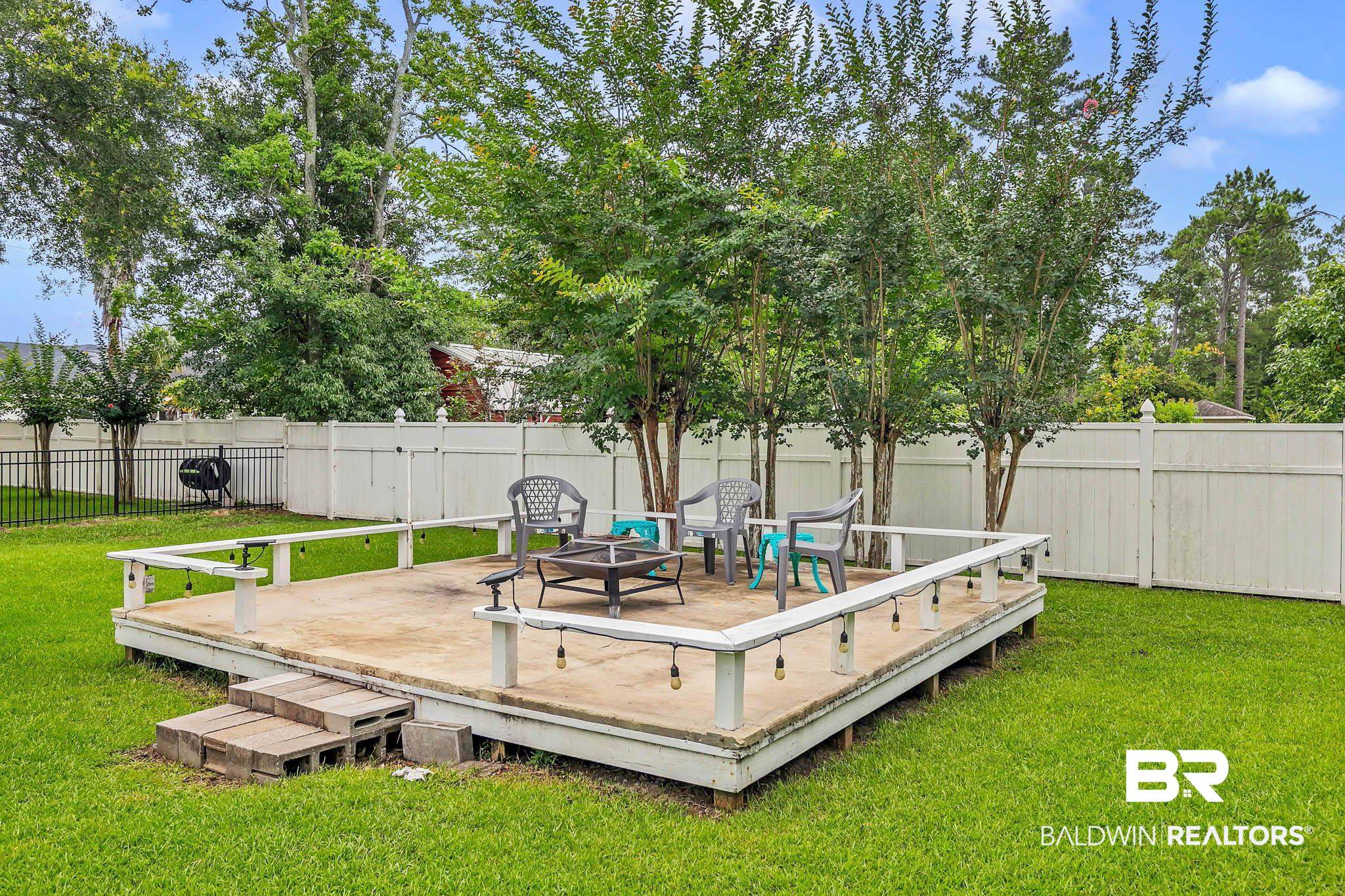 516 Juniper Place Drive Foley, AL 36535 - Photo 40 of 51 Wooden terrace with a fenced backyard and an outdoor fire pit