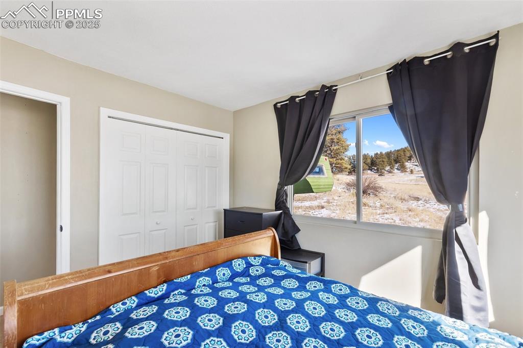 11 Valley Circle Guffey, CO 80820 - Photo 19 of 41 a bedroom with a bed and a window