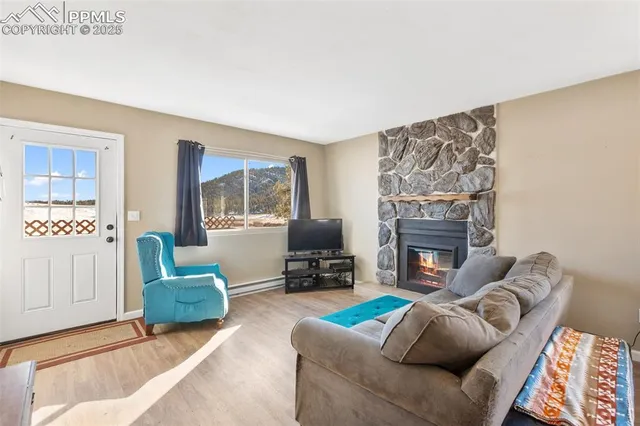 a living room with furniture and kitchen view