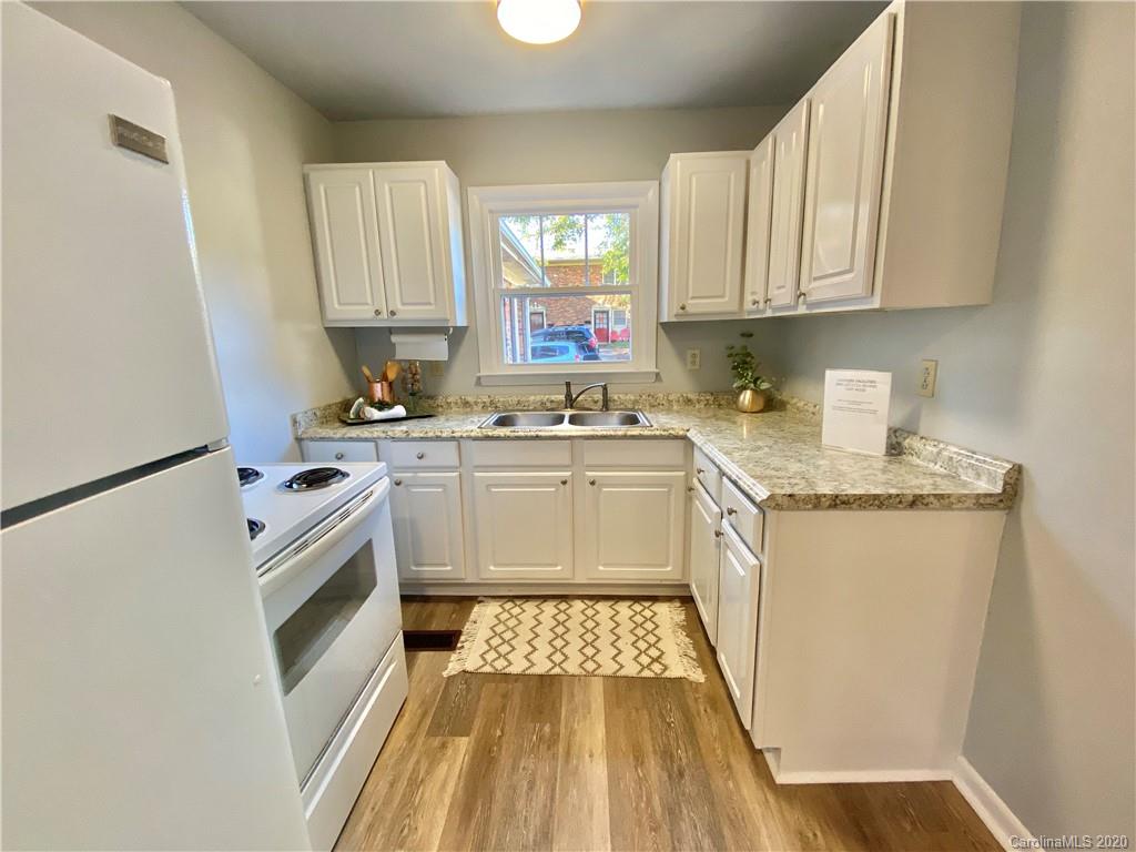 4232 Castleton Road Charlotte, NC 28211 - Photo 2 of 21 a kitchen with a sink stove and cabinets
