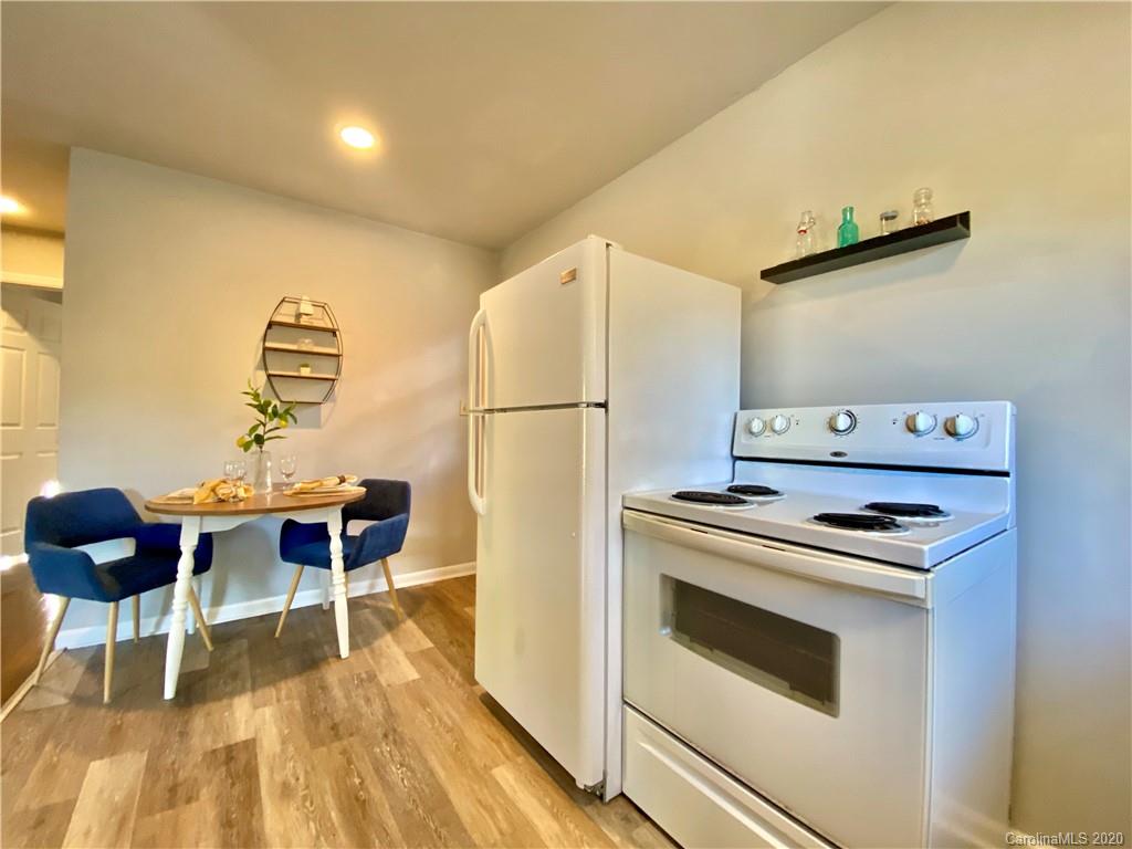 4232 Castleton Road Charlotte, NC 28211 - Photo 11 of 21 a kitchen with a stove a refrigerator and a dining table