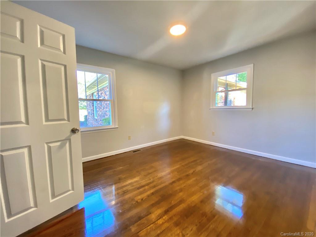4232 Castleton Road Charlotte, NC 28211 - Photo 14 of 21 an empty room with wooden floor and windows