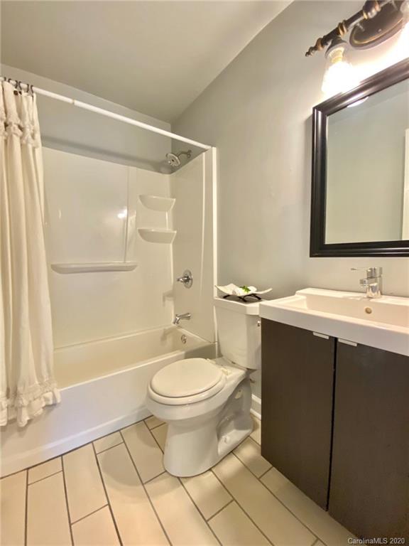 4232 Castleton Road Charlotte, NC 28211 - Photo 17 of 21 a bathroom with a sink toilet a mirror and shower