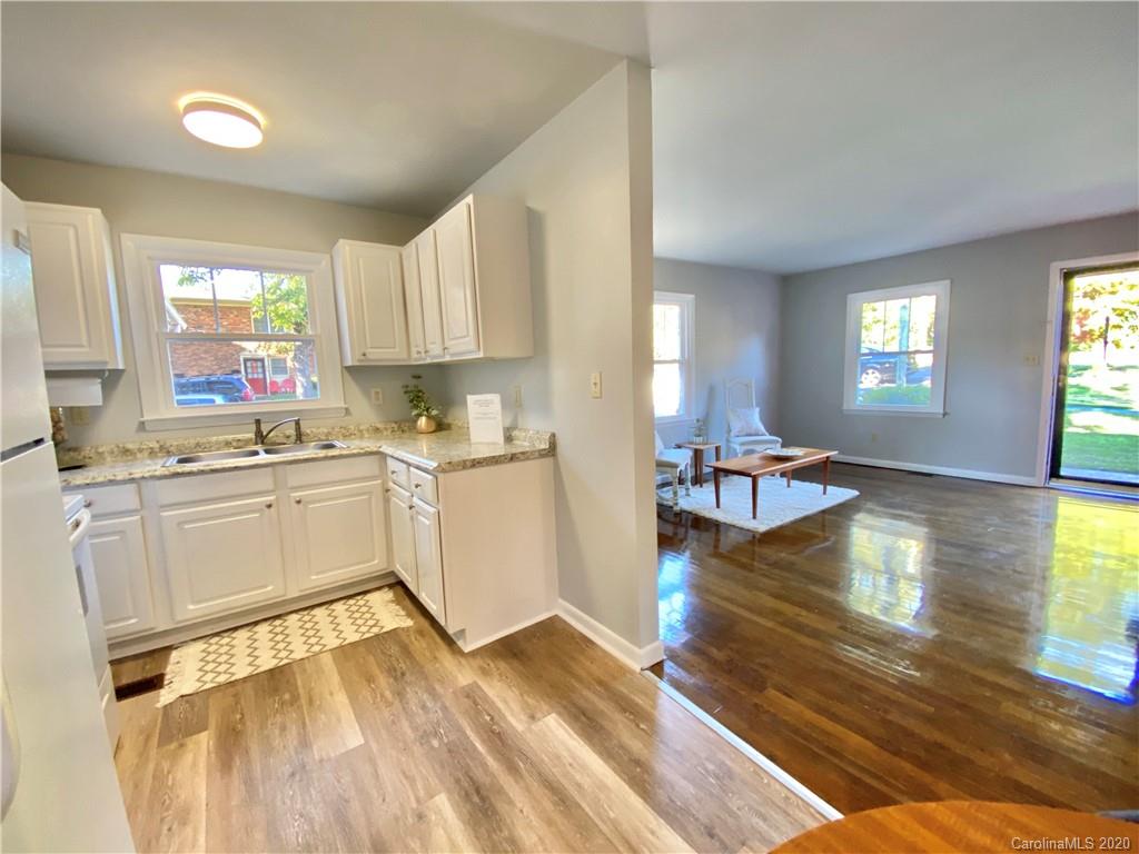 4232 Castleton Road Charlotte, NC 28211 - Photo 3 of 21 a kitchen with a refrigerator and white cabinets