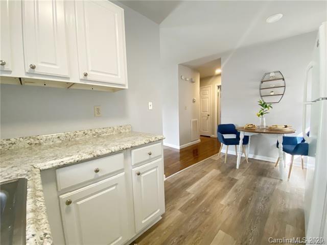 4232 Castleton Road Charlotte, NC 28211 - Photo 9 of 21 a kitchen with granite countertop a stove a sink and cabinets