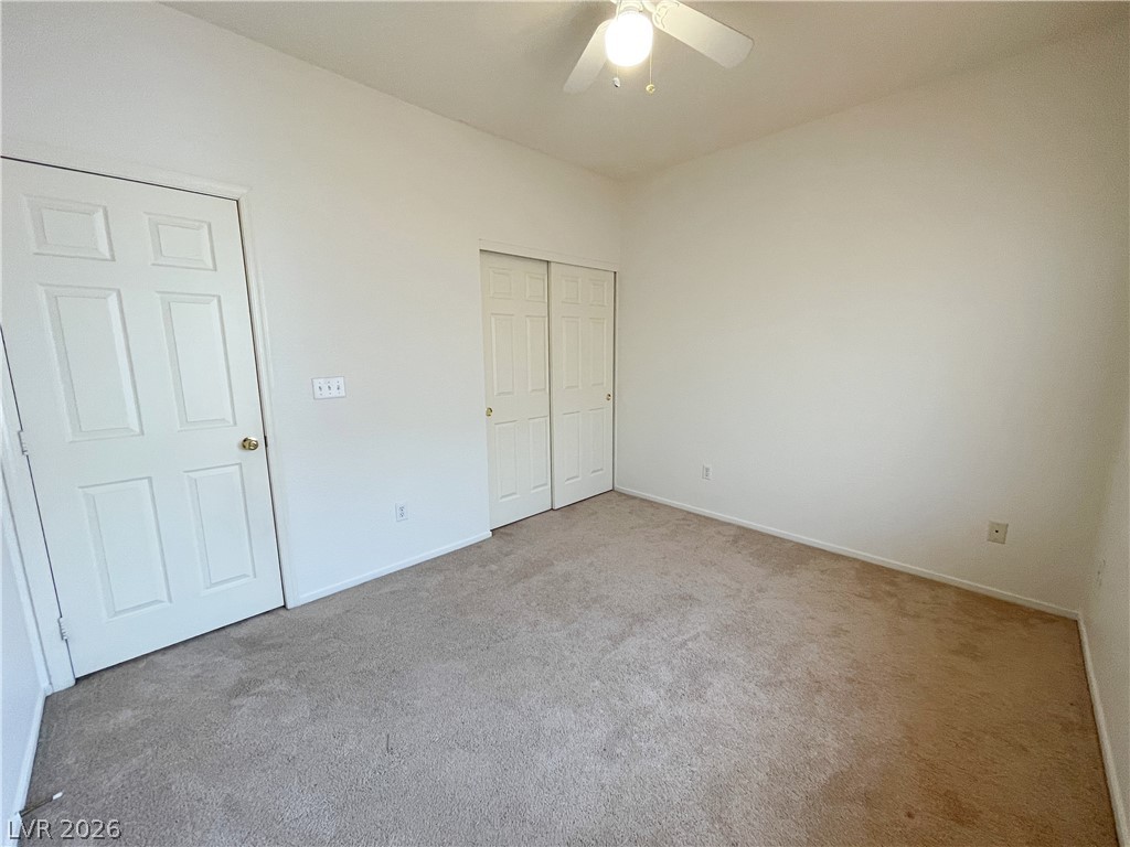 691 Principle Point Avenue Henderson, NV 89012 - Photo 26 of 30 A well-lit bedroom offering plush carpeting and ample closet space for comfortable living.
