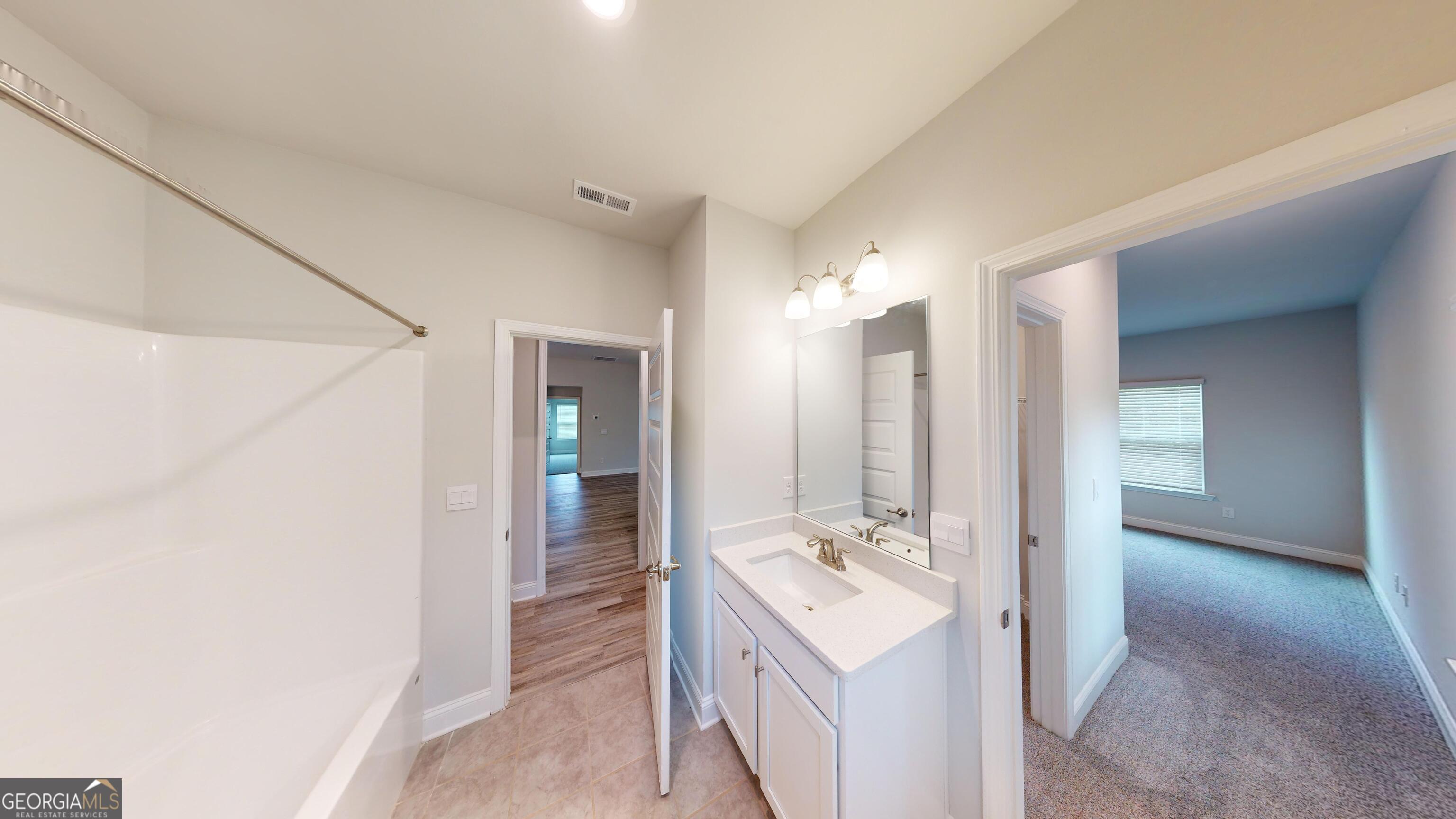 1021 Holiday Pass Griffin, GA 30223 - Photo 22 of 22 a bathroom with a double vanity sink and mirror