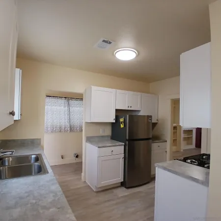 a kitchen with a refrigerator and a sink