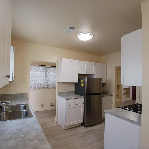 a kitchen with a refrigerator and a sink
