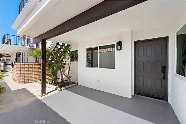 a view of a house with potted plants