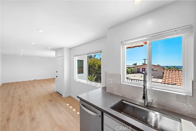 a kitchen with stainless steel appliances granite countertop a sink and a wooden cabinets