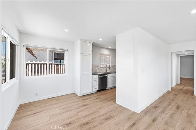 a kitchen with white cabinets and a sink