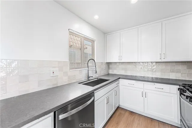 a kitchen with a sink and a window