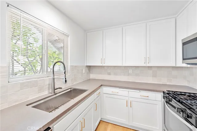 a kitchen with a sink and cabinets
