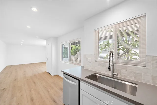 a kitchen with a sink and large window