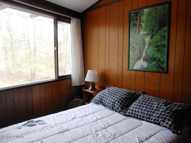 105 Ridge Road Hawley, PA 18428 - Photo 14 of 41 a bedroom with a bed window and lamp