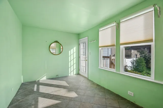 a view of a room that has a large window with kitchen view