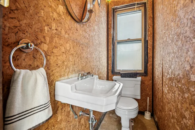 a bathroom with a sink toilet and mirror