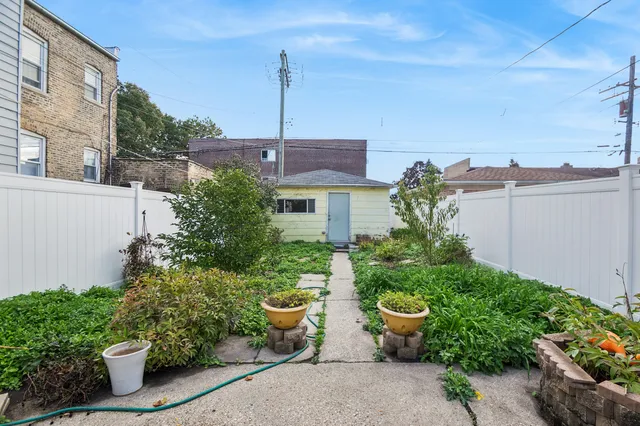 a front view of a house with potted plants