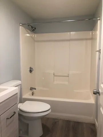 a bathroom with a toilet a sink and shower