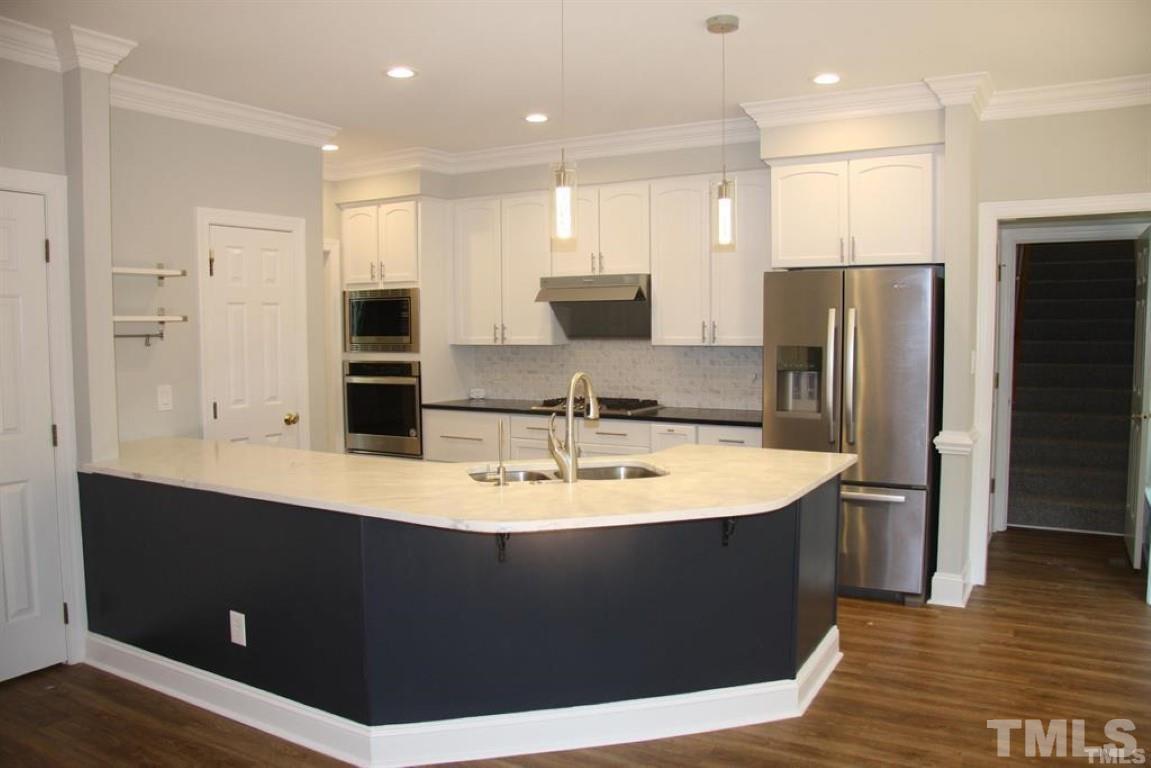 204 Morrow Mountain Drive Cary, NC 27513 - Photo 13 of 40 a large kitchen with kitchen island a sink appliances and cabinets