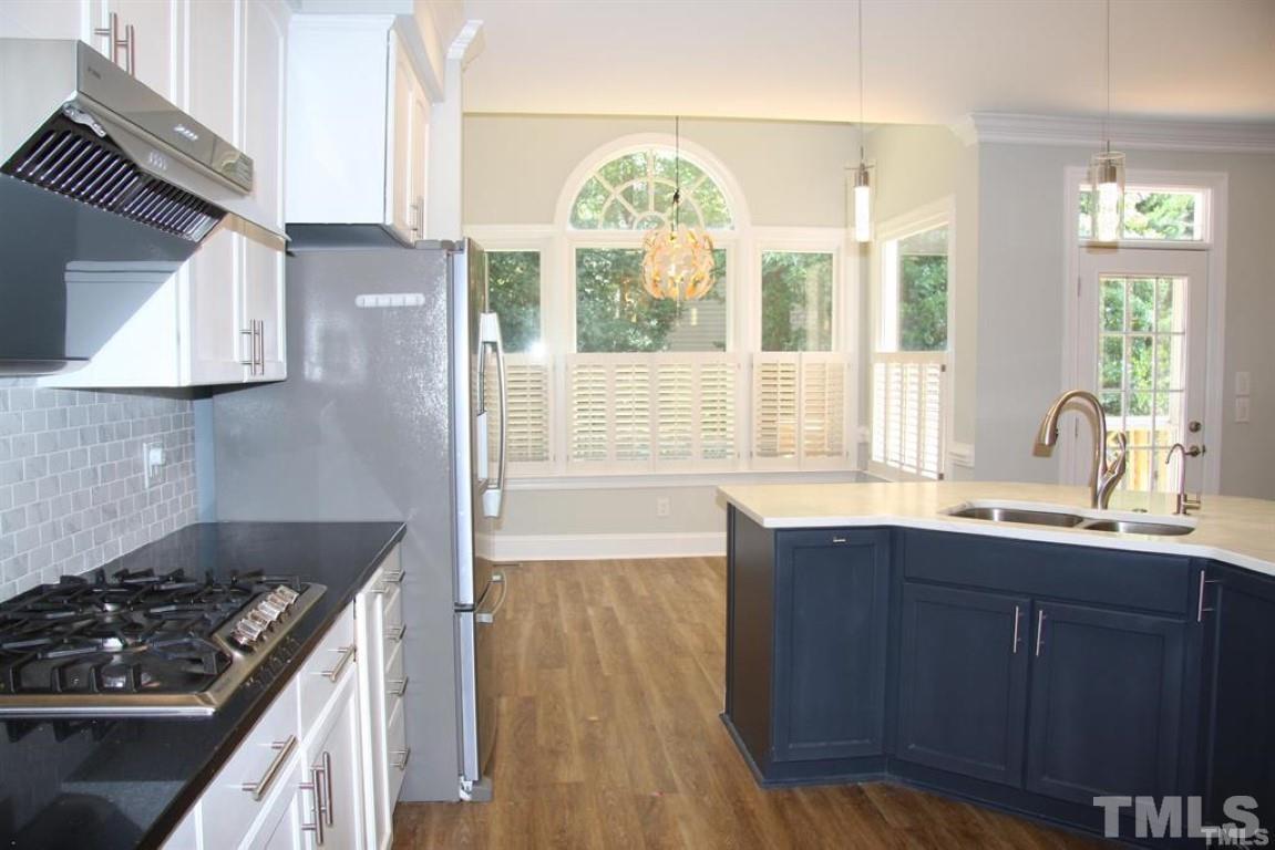 204 Morrow Mountain Drive Cary, NC 27513 - Photo 15 of 40 a kitchen with stainless steel appliances a stove a sink and a large window