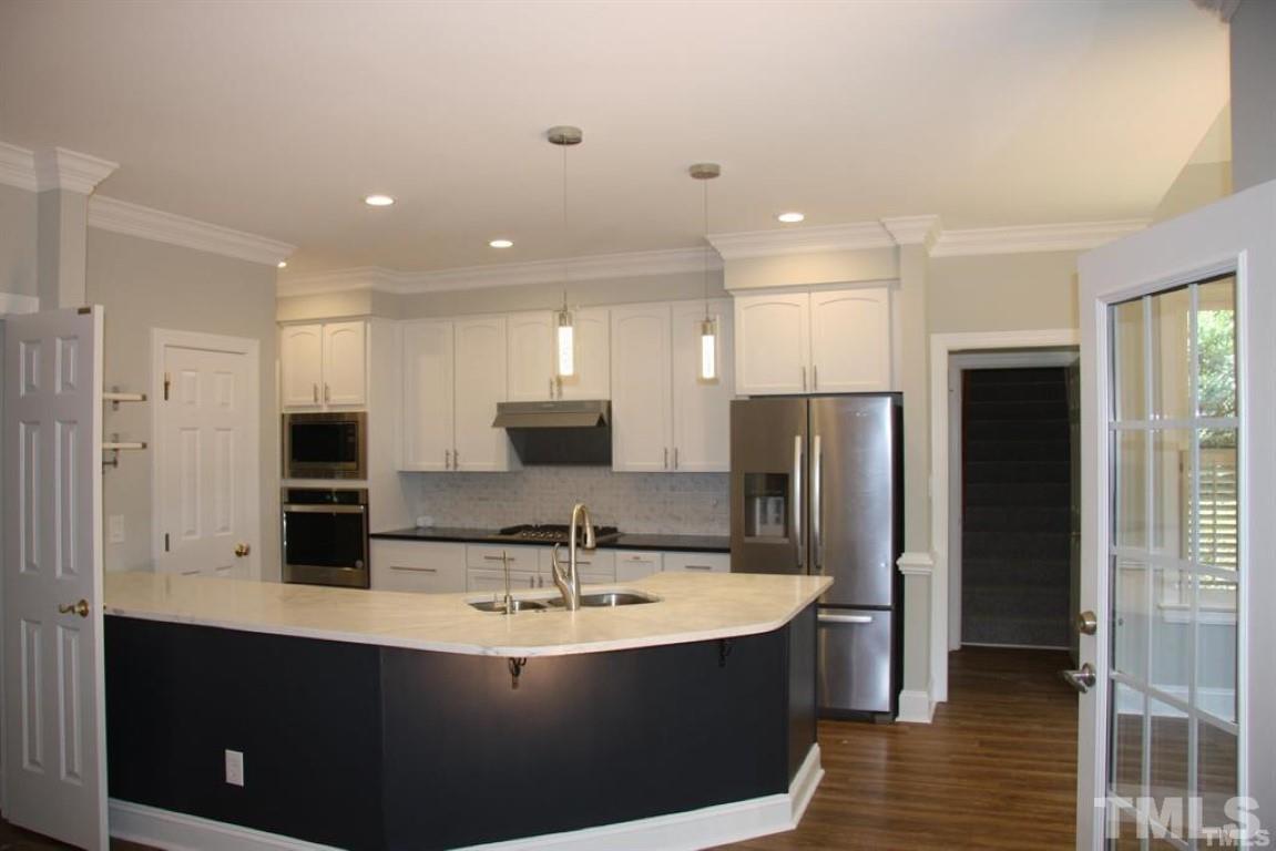 204 Morrow Mountain Drive Cary, NC 27513 - Photo 17 of 40 a view of kitchen with stainless steel appliances granite countertop a sink and a refrigerator