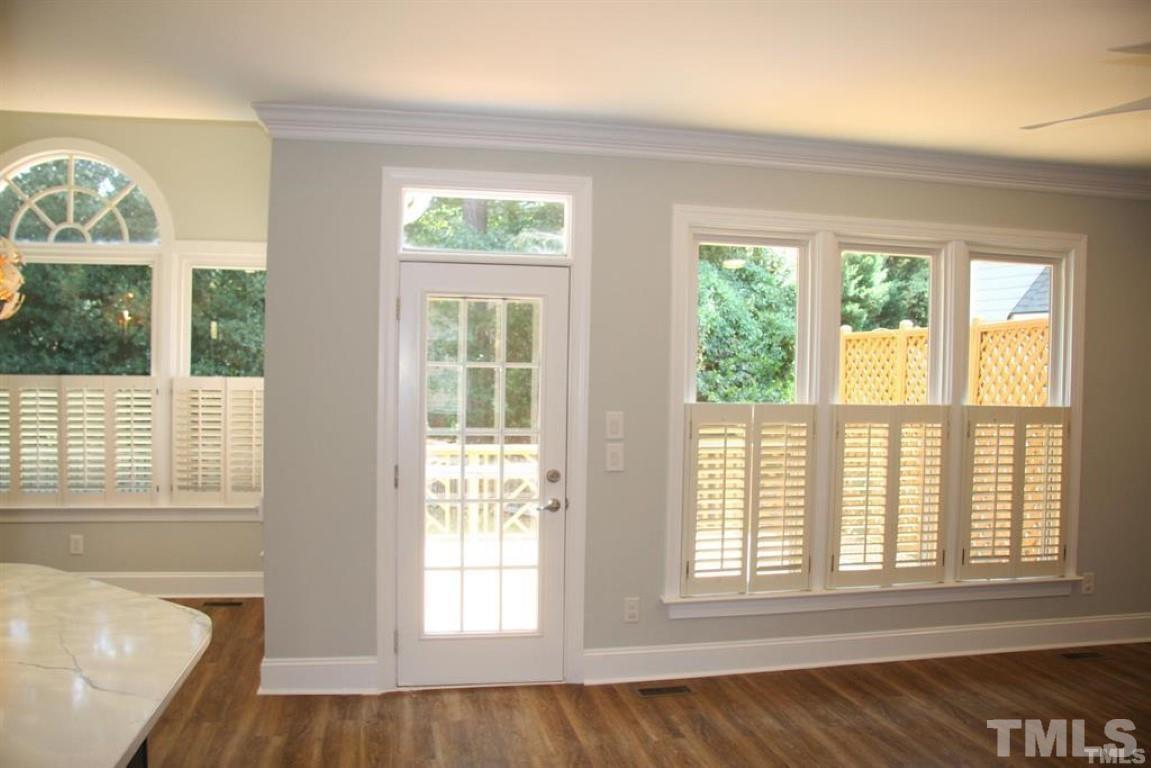 204 Morrow Mountain Drive Cary, NC 27513 - Photo 18 of 40 an empty room with wooden floor and windows