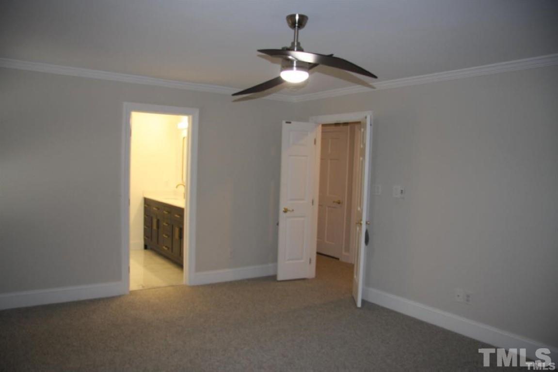 204 Morrow Mountain Drive Cary, NC 27513 - Photo 24 of 40 an empty room with a chandelier fan and a window