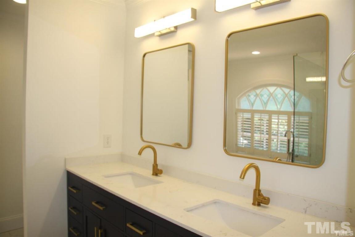 204 Morrow Mountain Drive Cary, NC 27513 - Photo 26 of 40 a bathroom with a sink and a mirror