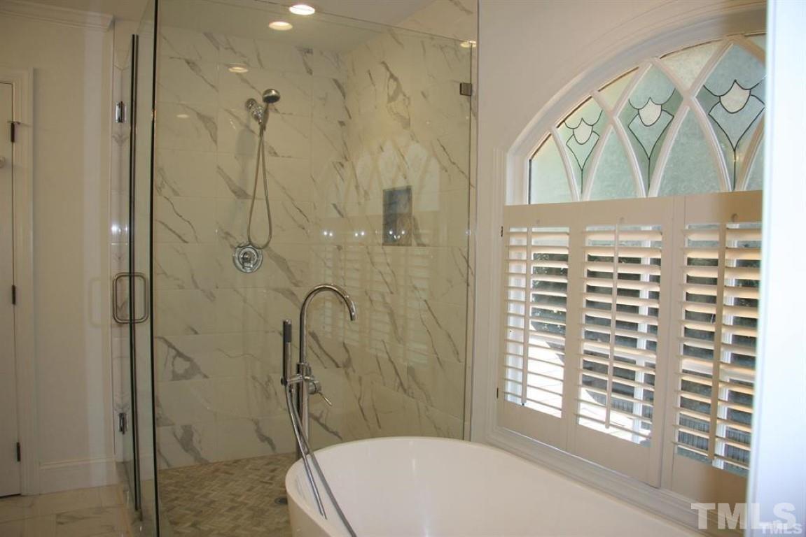 204 Morrow Mountain Drive Cary, NC 27513 - Photo 27 of 40 a bathroom with a bathtub and shower