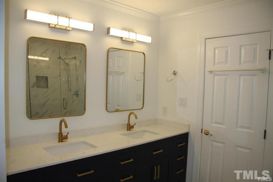 204 Morrow Mountain Drive Cary, NC 27513 - Photo 28 of 40 a bathroom with double vanity sinks and a mirror