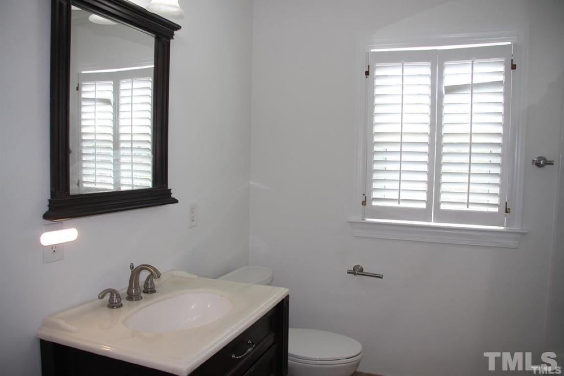 204 Morrow Mountain Drive Cary, NC 27513 - Photo 34 of 40 a bathroom with a sink toilet a mirror and window