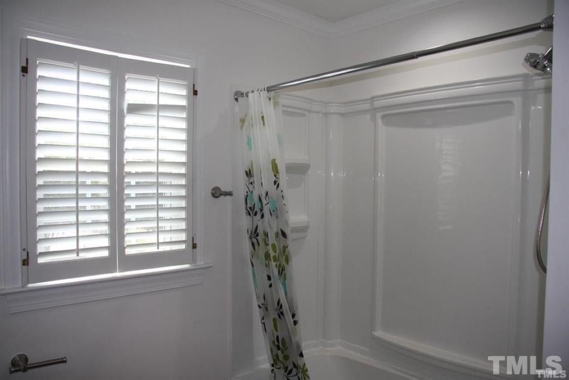 204 Morrow Mountain Drive Cary, NC 27513 - Photo 35 of 40 a bathroom with a shower curtain and a window