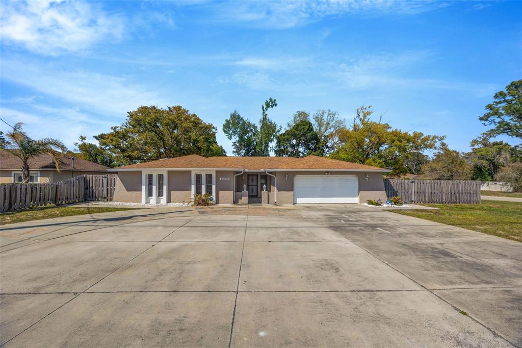 10199 Elgin Boulevard Spring Hill, FL 34608 - Photo 1 of 66 a view of a house with a yard and potted plants