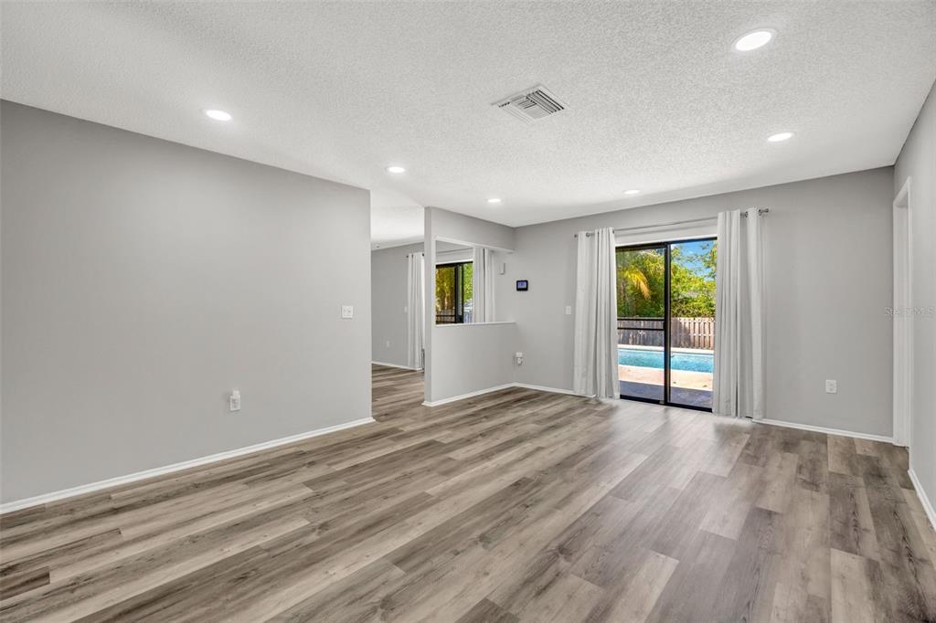 10199 Elgin Boulevard Spring Hill, FL 34608 - Photo 18 of 66 a view of an empty room with wooden floor and a window