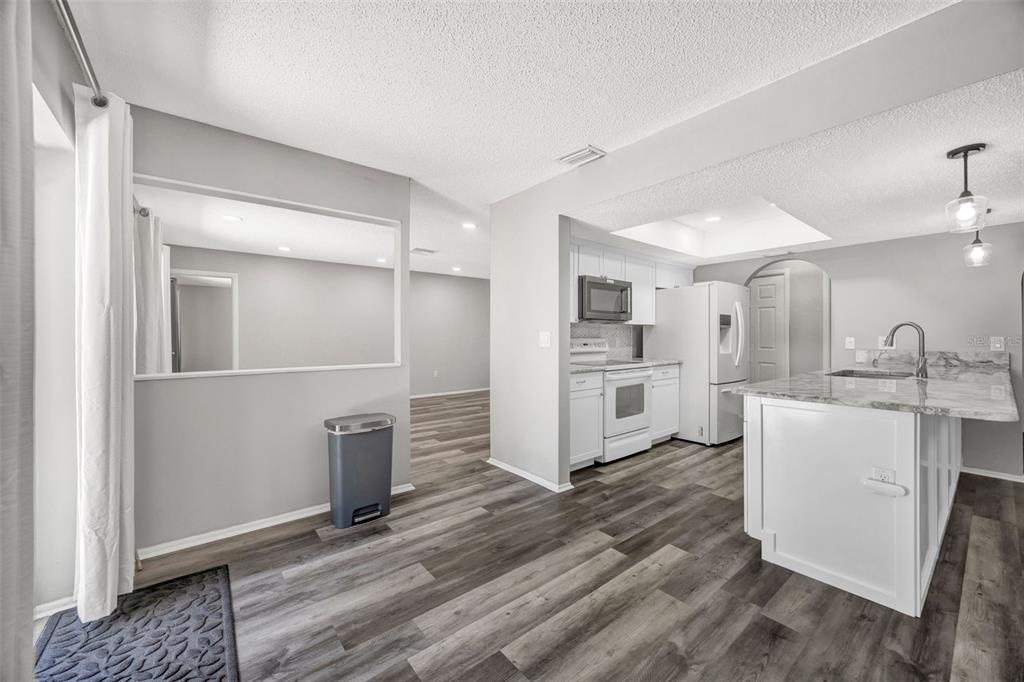 10199 Elgin Boulevard Spring Hill, FL 34608 - Photo 21 of 66 a kitchen with white cabinets and stainless steel appliances