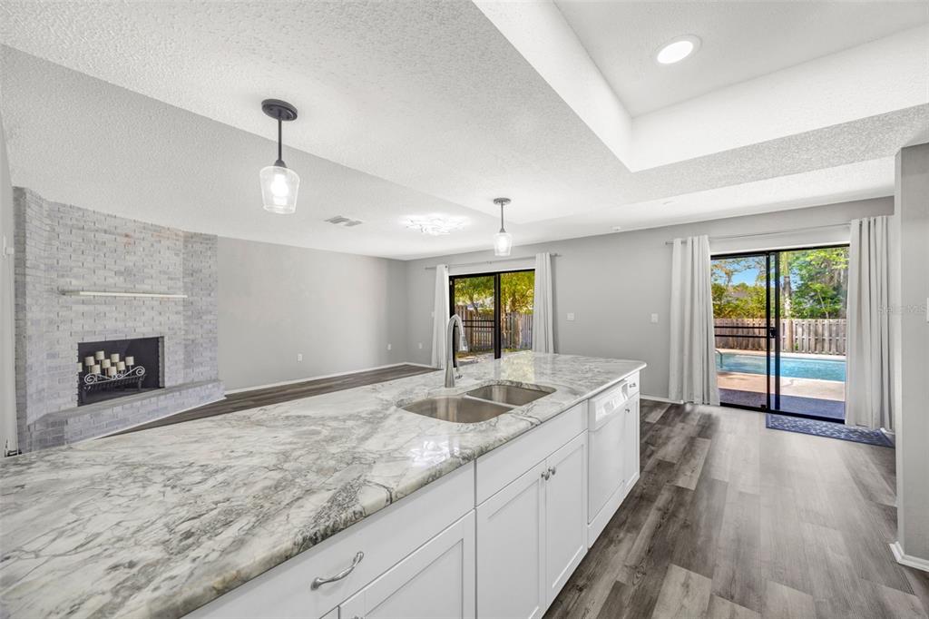 10199 Elgin Boulevard Spring Hill, FL 34608 - Photo 27 of 66 a spacious bathroom with a granite countertop sink and a large mirror