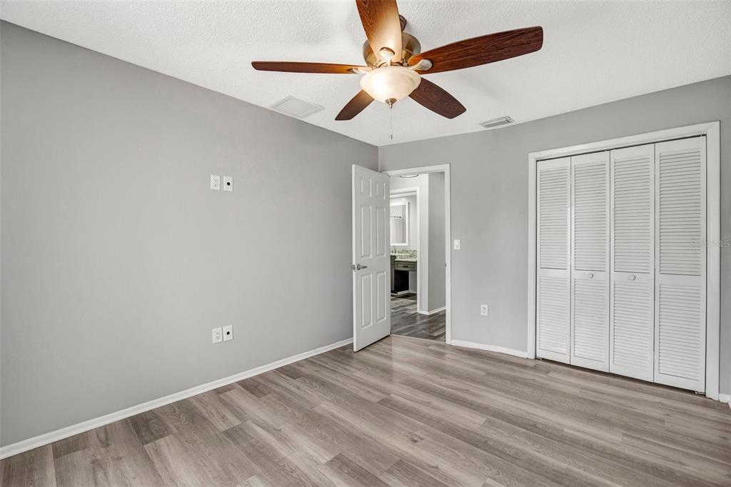 10199 Elgin Boulevard Spring Hill, FL 34608 - Photo 36 of 66 an empty room with closet and a ceiling fan