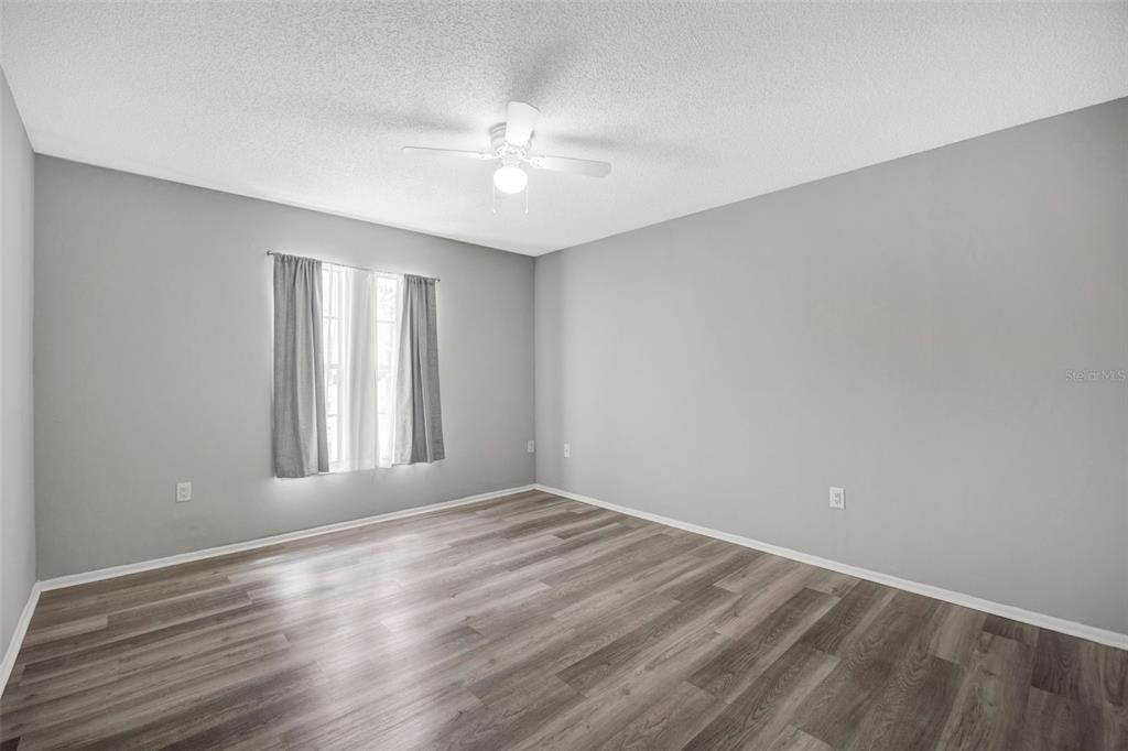 10199 Elgin Boulevard Spring Hill, FL 34608 - Photo 39 of 66 wooden floor in an empty room with a window
